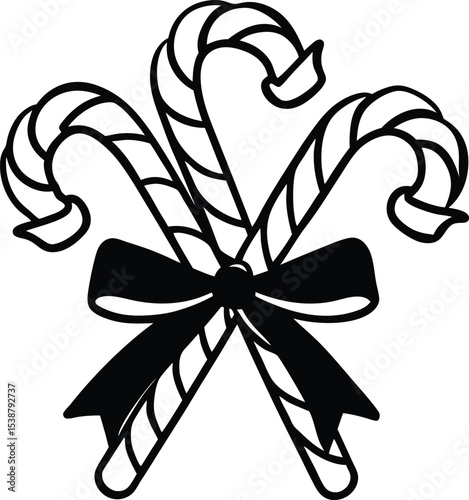 Three Striped Christmas Candy Canes Crossed and Tied Together with a Decorative Bow