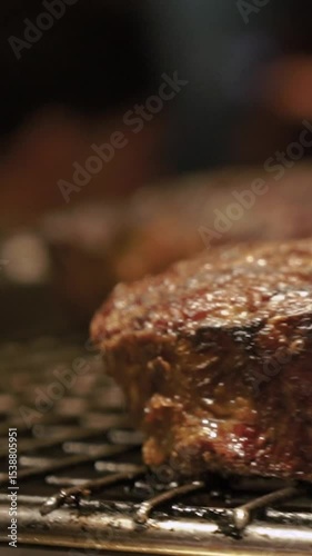 Meat juicy beef steak on fire is fried in an expensive restaurant. Hot dish barbecue raw on the bone with smoke