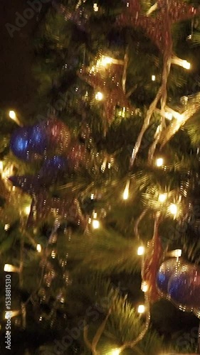 Decorated with toys green festive tree as a symbol of the New Year holiday. Garlands and decorations for Christmas festivities