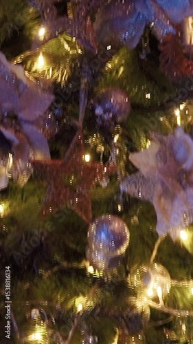 Decorated with toys green festive tree as a symbol of the New Year holiday. Garlands and decorations for Christmas festivities