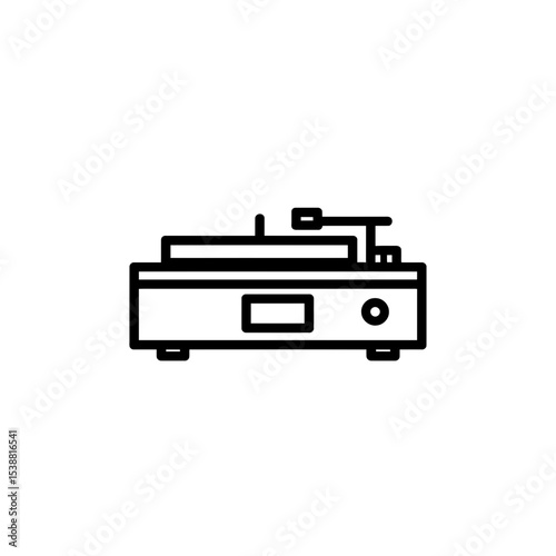 Vintage turntable plays music indoors against plain backdrop