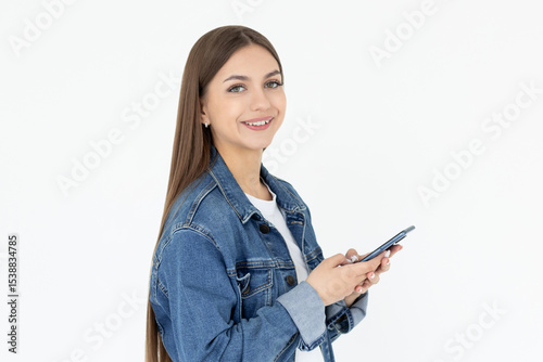 Happy pretty young woman model holding smartphone looking at camera, smiling girl using mobile apps on cell phone standing isolated on white background with cellphone.
