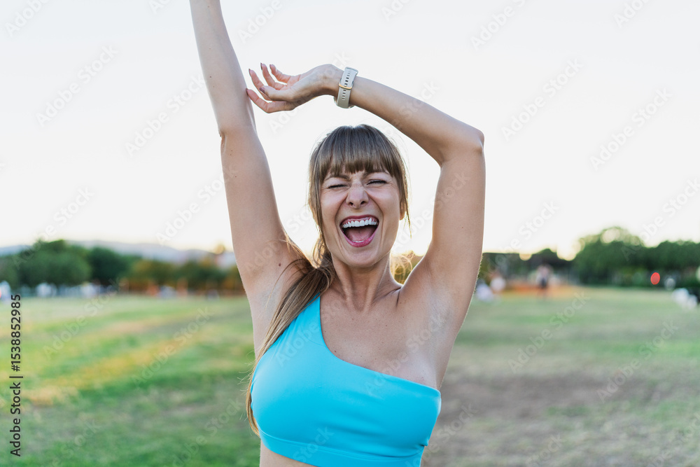 A joyful woman celebrating her workout success outdoors in the park, embracing a positive and active lifestyle. Concept of fitness, happiness, and well-being. A joyful woman celebrating her workout success outdoors in the park, embracing a positive and active lifestyle. Concept of fitness, happiness, and well-being.