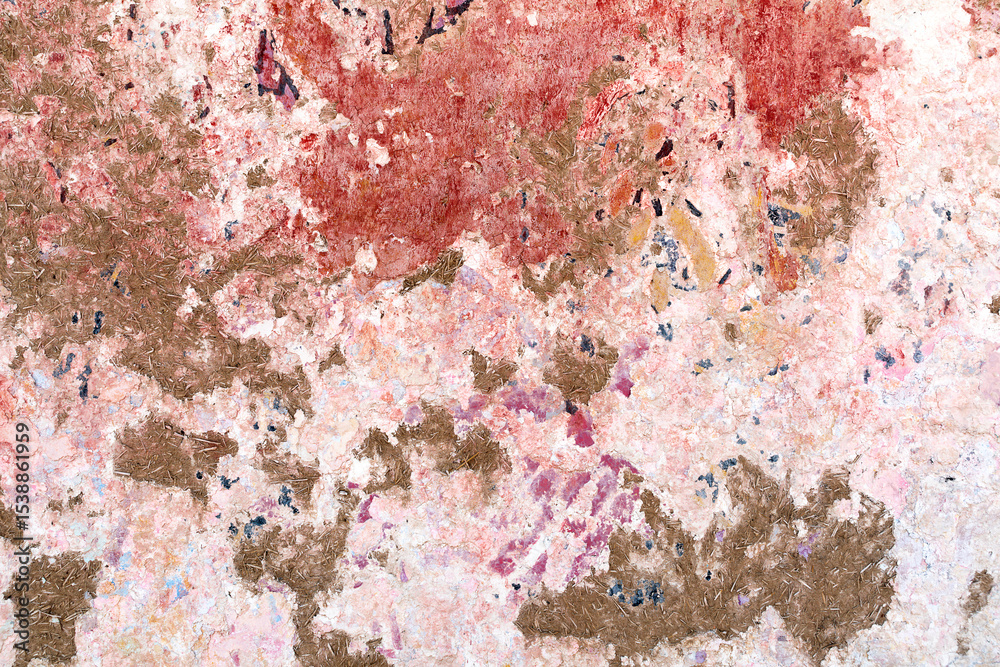 Naklejka premium old adobe wall with peeling paint in different colors