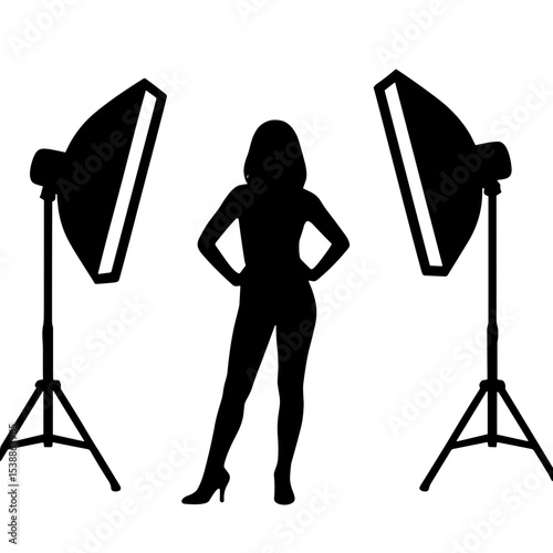Silhouette of model posing confidently between studio lights for Photographer's Day  