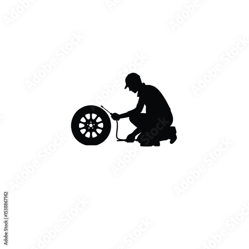 mechanic fixing tire silhouette on white background