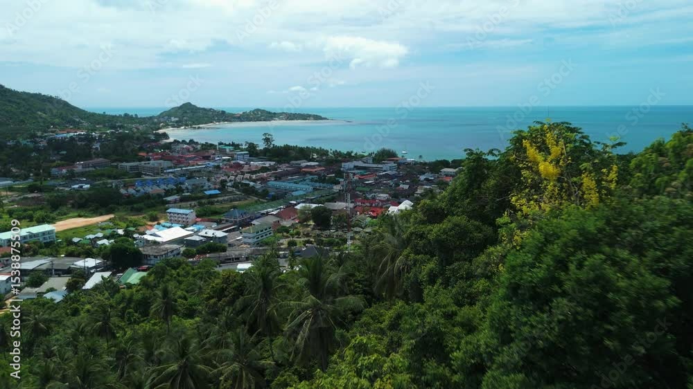 Lush tropical jungle foliage frames tranquil turquoise bay and buildings of koh tao island, popular tourist destination in thailand known for its stunning beaches and vibrant coral reefs