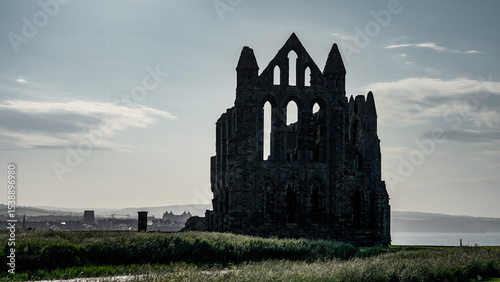 Whitby Abbey's silhouette standing tall against a cloudy sky in North York Moors National Park