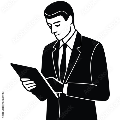 A man in a dark suit and tie uses a tablet computer he holds in his hands while standing against a white background the image is in black and white