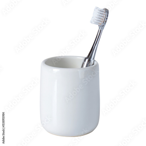 A white toothbrush is in a white cup