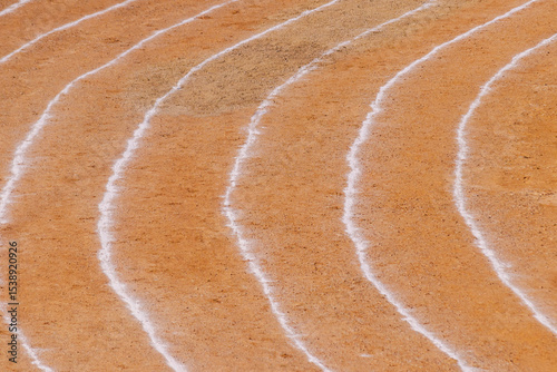 Empty athletics track and white stripes in a stadium