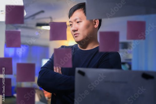 Photography Business team stands around a flip chart, brainstorming app structure and workfl