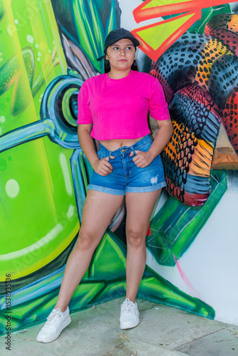 Latina Girl in Fashion Pose by Urban Graffiti Wall