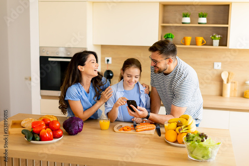 Joyful family cooking toget...
