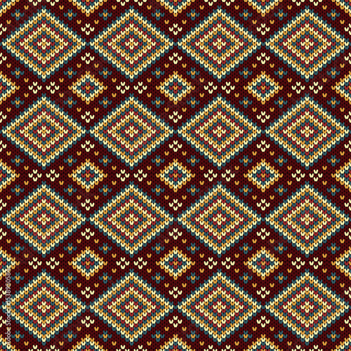 Multicolored geometric square pattern on a red needle background in a weaving pattern.