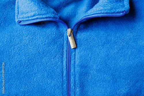 Detail view of a blue fleece zip up jacket top