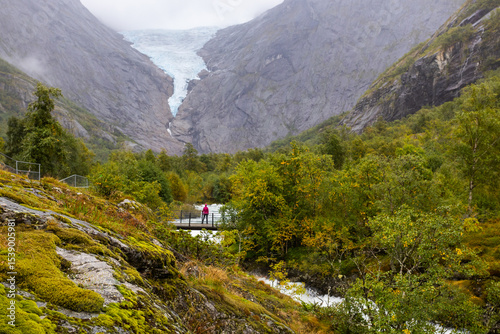Young women in Briksdal glacier valley in south Norway, Europe