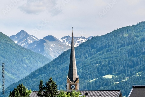 Church tower of Bad Hofgastein in front of the Austrian Alps
