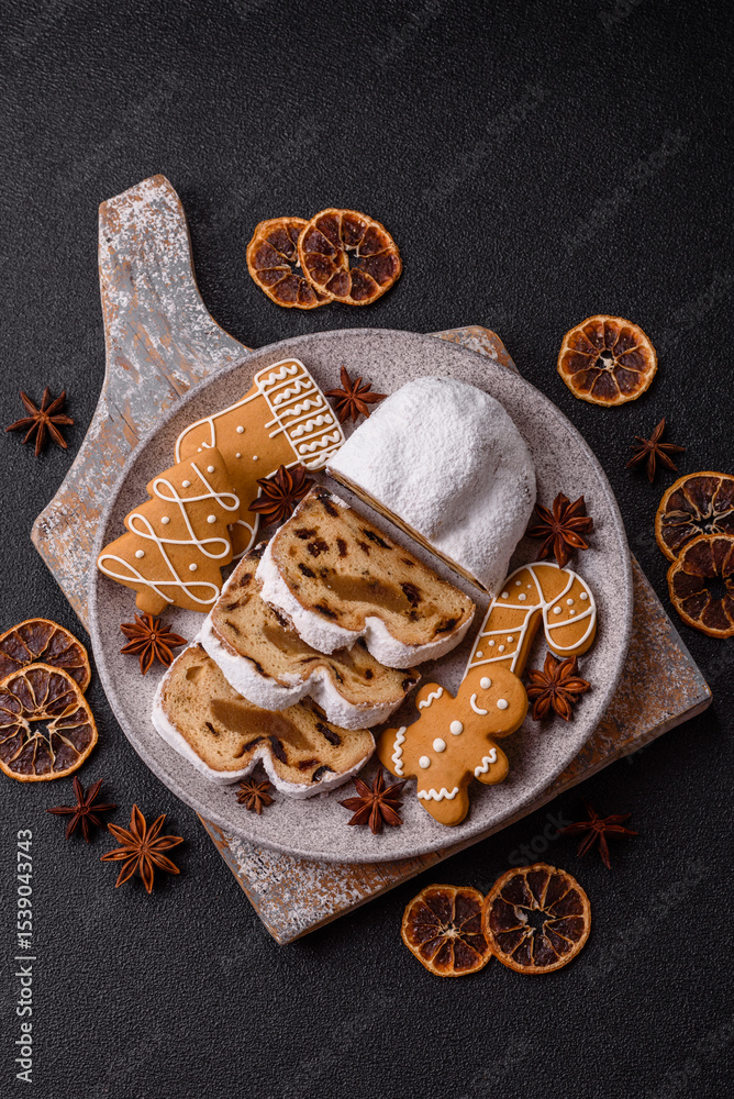 Fototapeta premium Christmas Stollen, a German sweet cake with marzipan and fruit. Winter Christmas Stollen