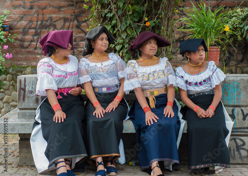 Indigenous colombian women showing traditional clothing sitting on bench