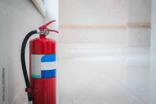 Fire extinguishers on floor available in fire emergency.