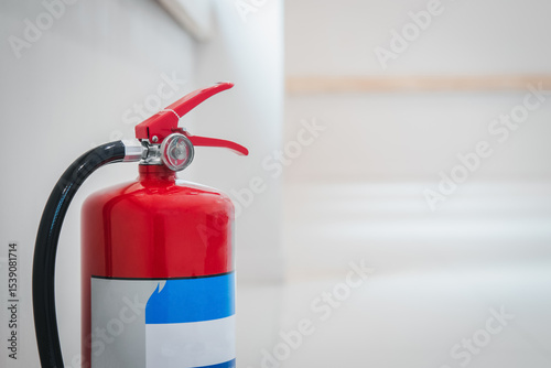 Fire extinguishers on floor available in fire emergency.