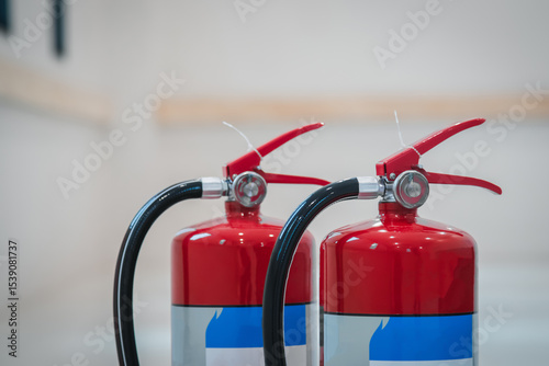 Fire extinguishers on floor available in fire emergency.
