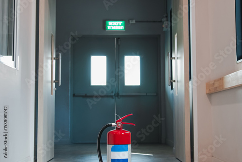 Fire extinguishers on floor available in fire emergency.