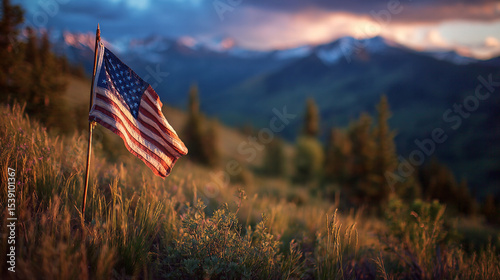 Fireworks bursting behind a waving flag in a mountain meadow at dusk