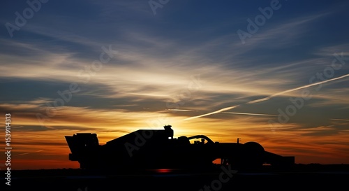 Silhouette formula one car racing at sunset for motorsport enthusiasts and racing car wallpapers hd download