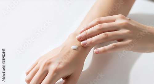 Wallpaper Mural Woman applying a drop of cosmetic cream on her hand. Closeup of skin moisturizing and body care. Skincare and beauty concept on a white background with soft light Torontodigital.ca