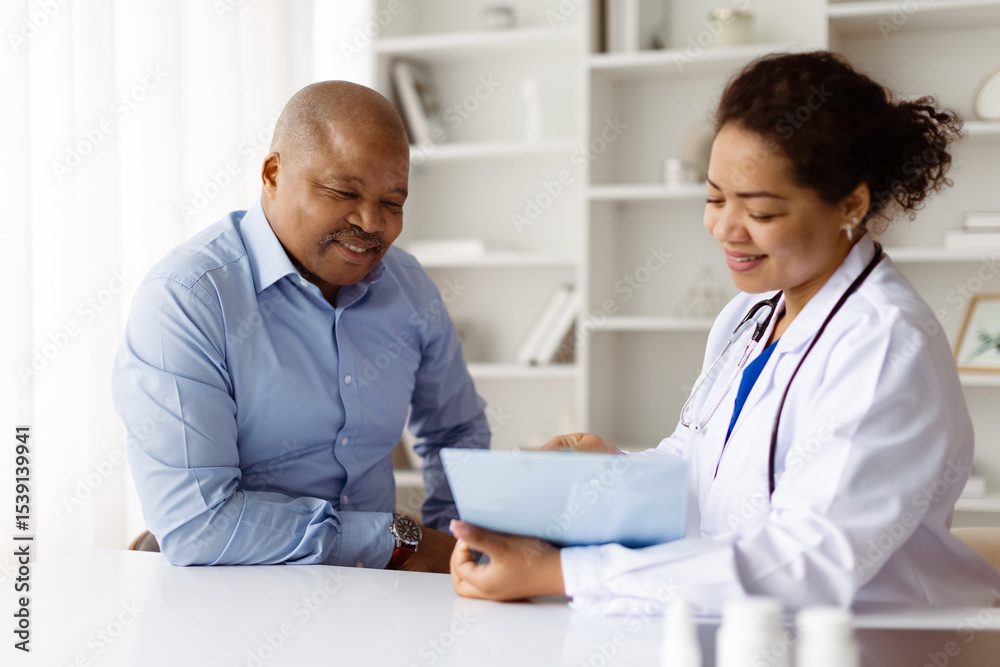 Fototapeta premium Happy African American doctor reviewing medical records with smiling black mature male patient during visit in modern clinic, therapist woman discussing test results with man, closeup
