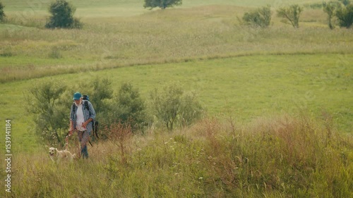 Therapeutic Hiking, Natural Rehabilitation. Senior Man With Backpack Treks Through Mountains With His Dog. A Calm, Healing Journey of Mobility Recovery and Outdoor Wellness After Retirement