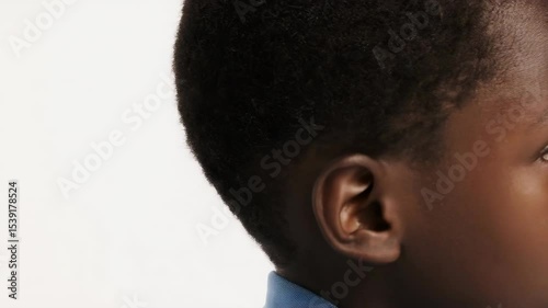 photo portrait of a handsome young black African afro American model teen boy looking forward. child ad with copy space, cute, kids, children
