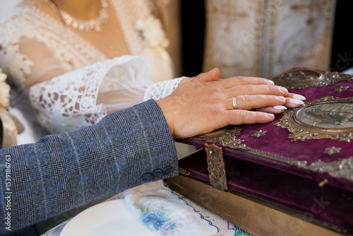 Orthodox Jewish Wedding Ceremony with Ring Exchange. Rich Purple Bible and Traditional Attire, Close-Up Focus on Hands, Texture, Faith, Love