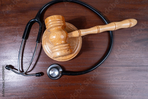 A powerful visual of a gavel and stethoscope placed together on a desk symbolizes the legal scrutiny over medical practices.