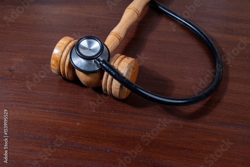 A powerful visual of a gavel and stethoscope placed together on a desk symbolizes the legal scrutiny over medical practices.