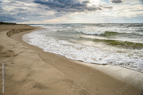 Krynica Morska, Poland - August 17, 2021. Nowa Karczma Beach near Russian border on Vistula Spit - wave covering sand on the shore