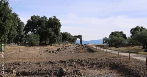 Roman ruins of Caparra with Decumanus Maximus and triumphal arch.