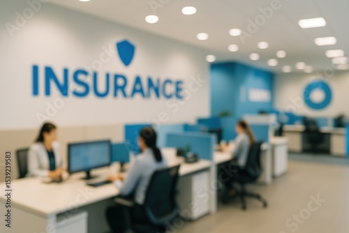 Blurred view of a women working in an open plan office space. Business environment for general commercial use.