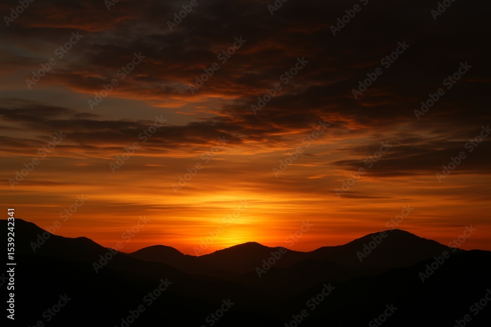 Fototapeta premium Fiery Sunrise Over Majestic Mountains