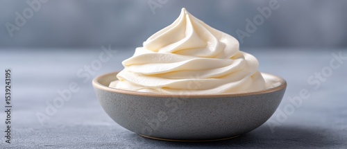 Bowl filled with a swirl of soft serve ice cream. Frozen dessert, sweet treat, vanilla flavor, creamy, cold, snack