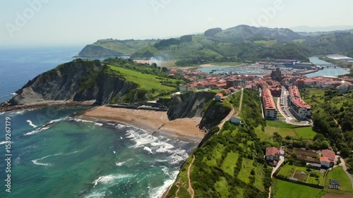 Aerial view of zumaia, basque country, spain, featuring itzurun beach, the town, and the harbor