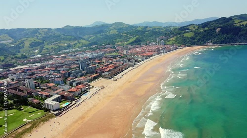 Scenic aerial perspective of zarautz town, beach, and coastline in basque country, spain, during a sunny summer day