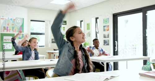 In school, multiracial students raising hands eagerly in classroom, engaging in lesson