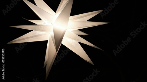 Christmas lights stars on tree branches in the dark.White lanterns in the night sky.Christmas decorative decorations on the street.Festive mood background. 4k footage