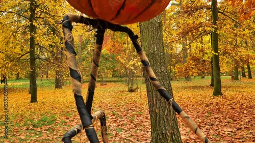 Jack Lantern pumpkin sculpture in autumn park.Pumpkin Horror Monster. Halloween holiday symbol.Festive decoration for autumn holidays. 4k footage