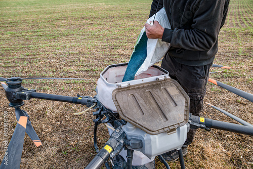 Farmer technicians prepare to remotely fly agricultural drones to fly to spray fertilizer in fields. Agricultural technology smart farm concept.