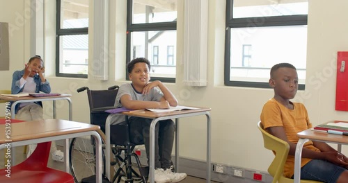 In school, diverse multiracial students listening attentively during lesson, engaged in learning