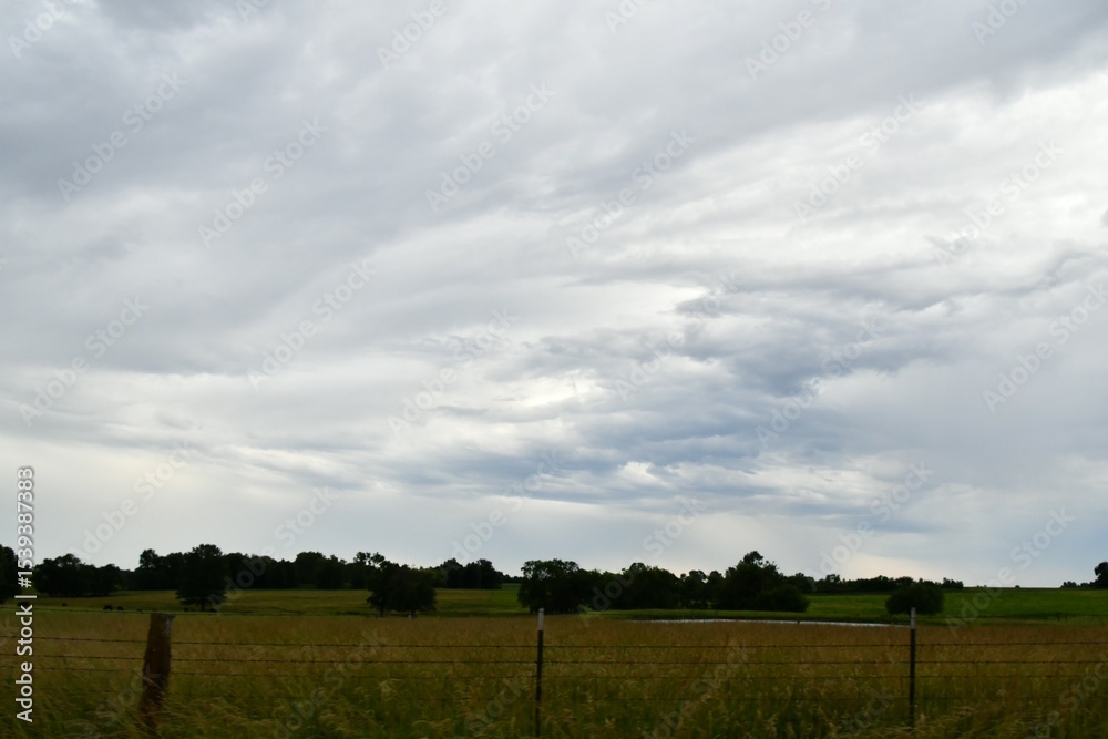 Fototapeta premium Clouds Over a Farm Field